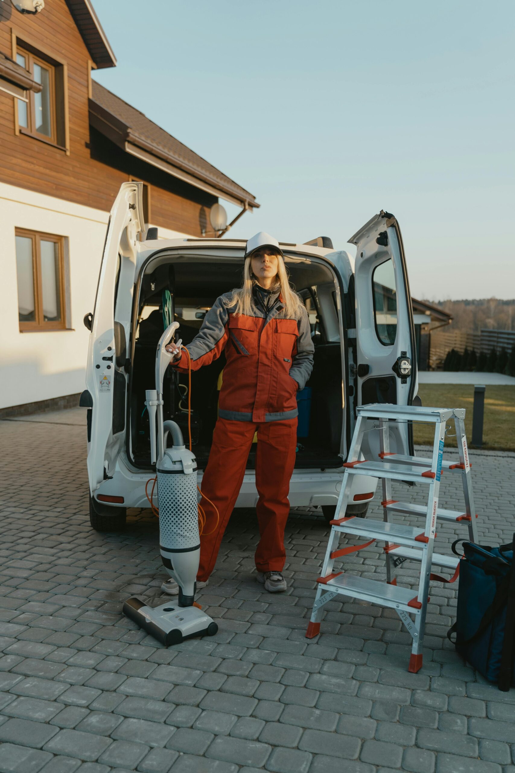 person with corporate cleaning equipment and van